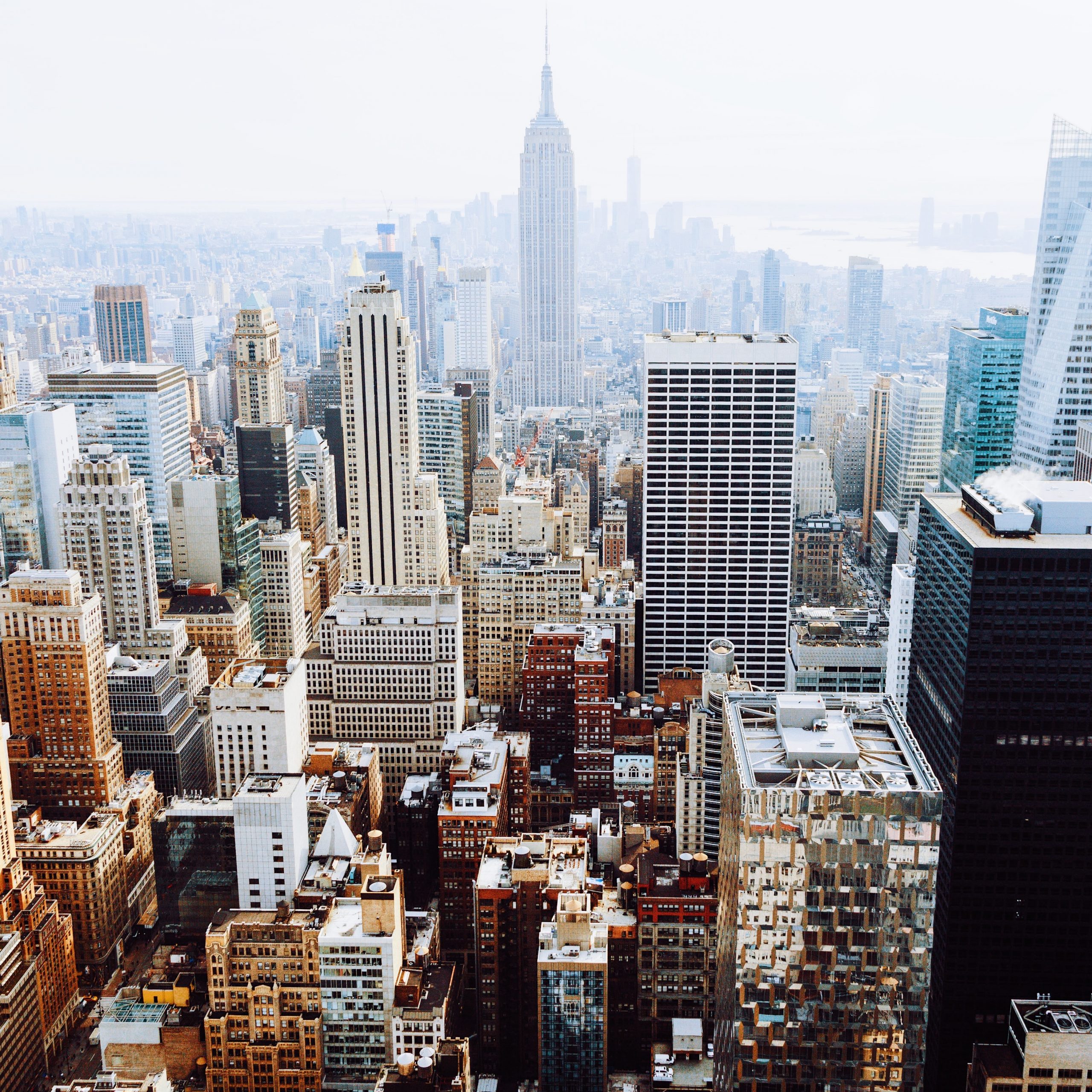 birds-eye view photo of city buildings with fog