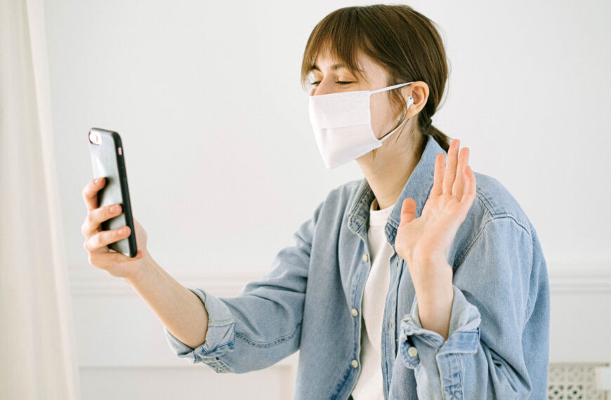 Woman in face mask having video call