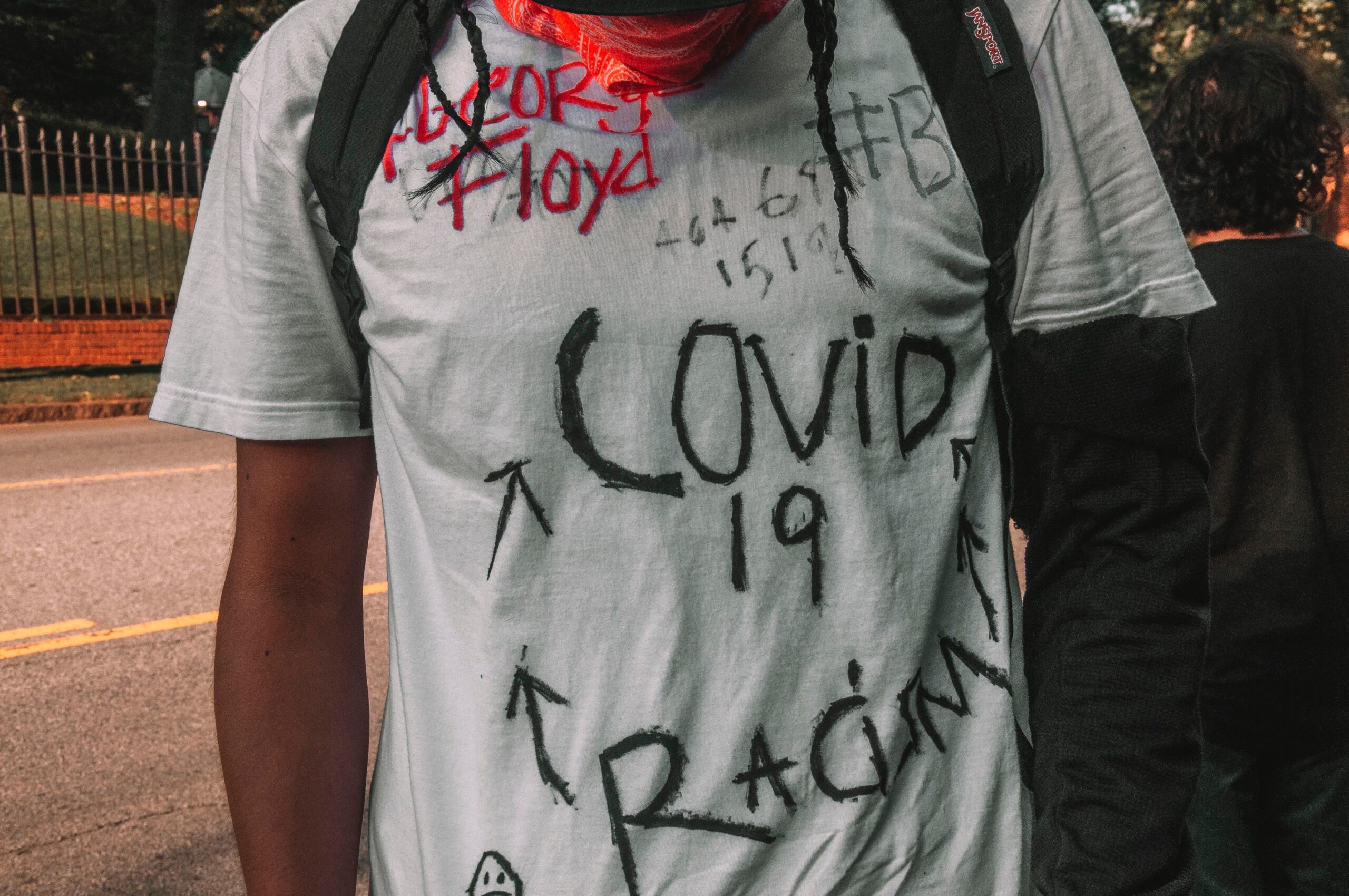 a protestor's shirt with handwritten messages