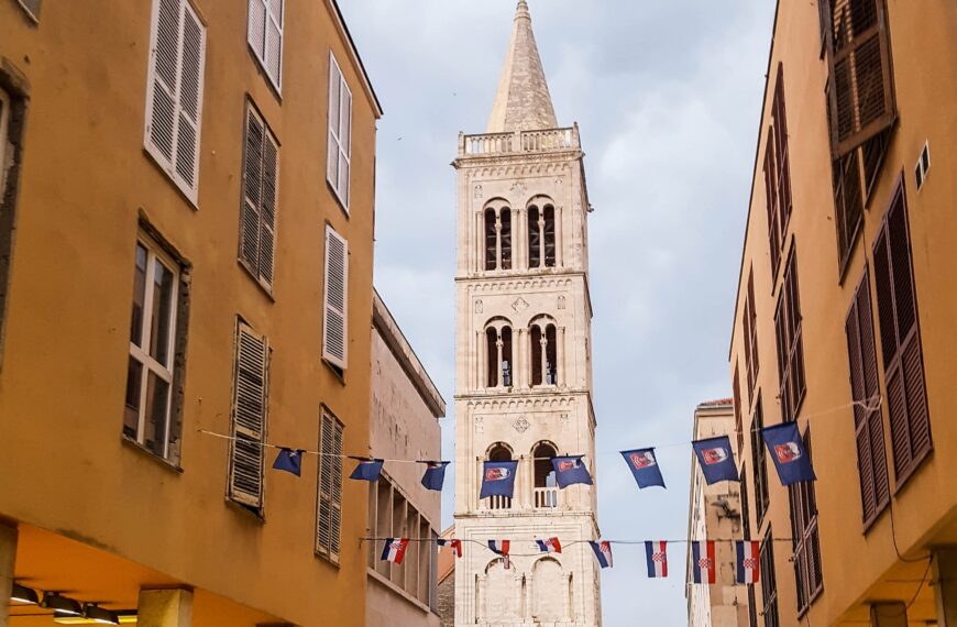 people walking on street near beige concrete building during daytime