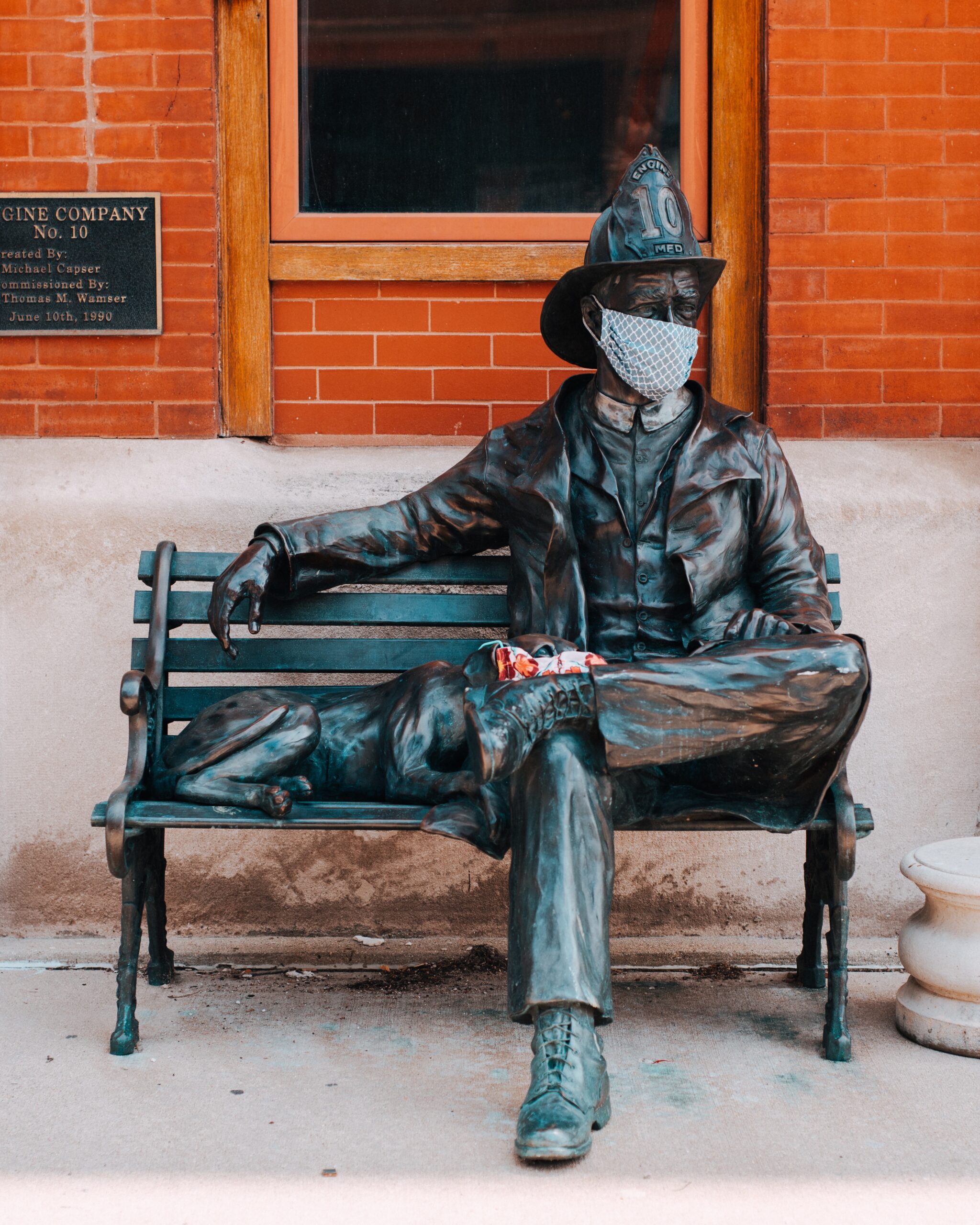 Masks were left on a statue of a fireman and his dog in Milwaukee's Third Ward. These are amongst several displays of solidarity during Covid-19.