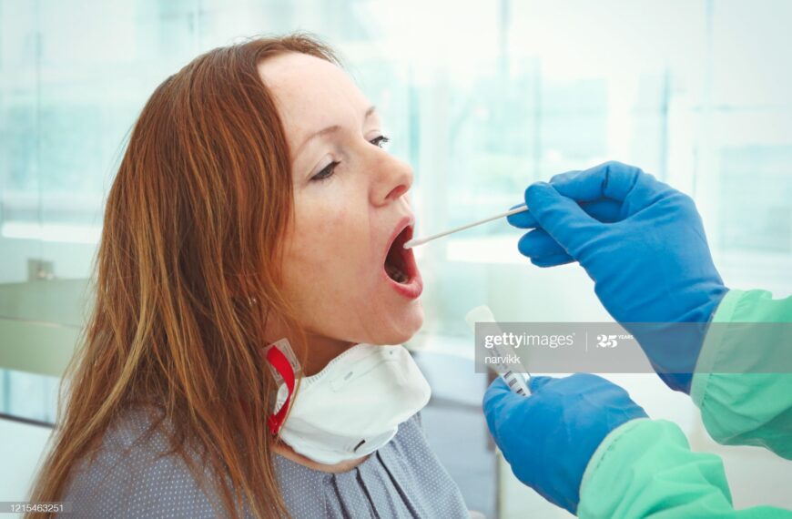 Medic taking sample from patients mouth for coronavirus testing