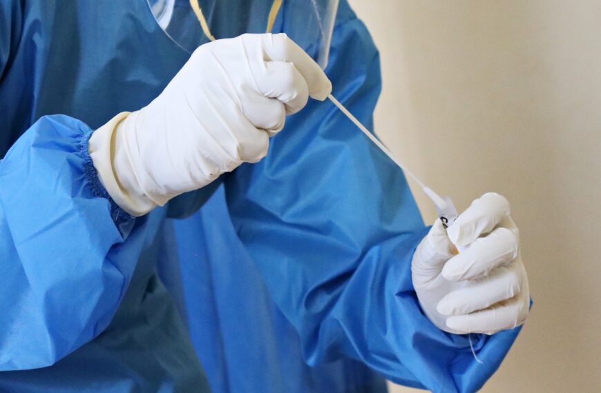 a laboratory worker takes a swab test