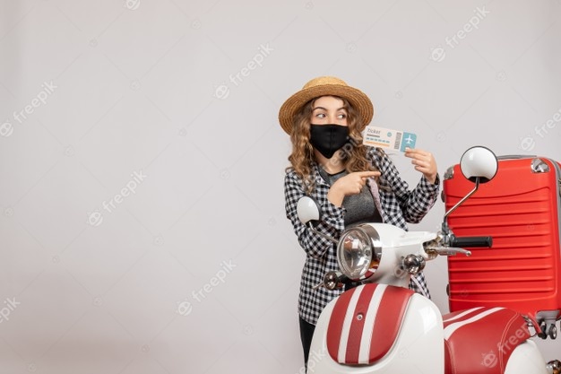 front-view-young-girl-with-black-mask-holding-ticket-pointing-right-near-red-moped